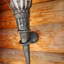 A wrought iron torch in a summer house